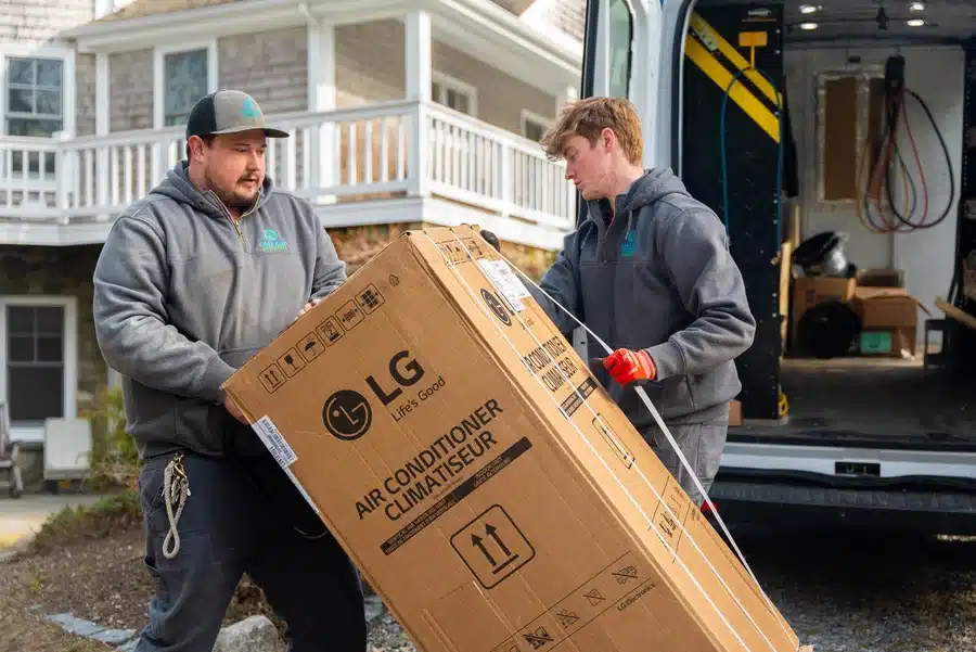 Cape Heating AC & Electric technicians installing AC in residential home on Cape Cod, MA.